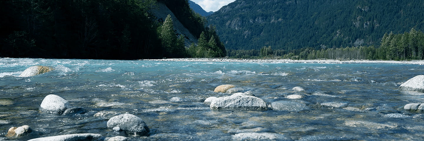 A blue river with a rock bed in British Columbia, Canada