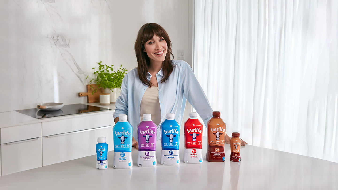 Bianca Gervais smiling behind several fairlife product bottles