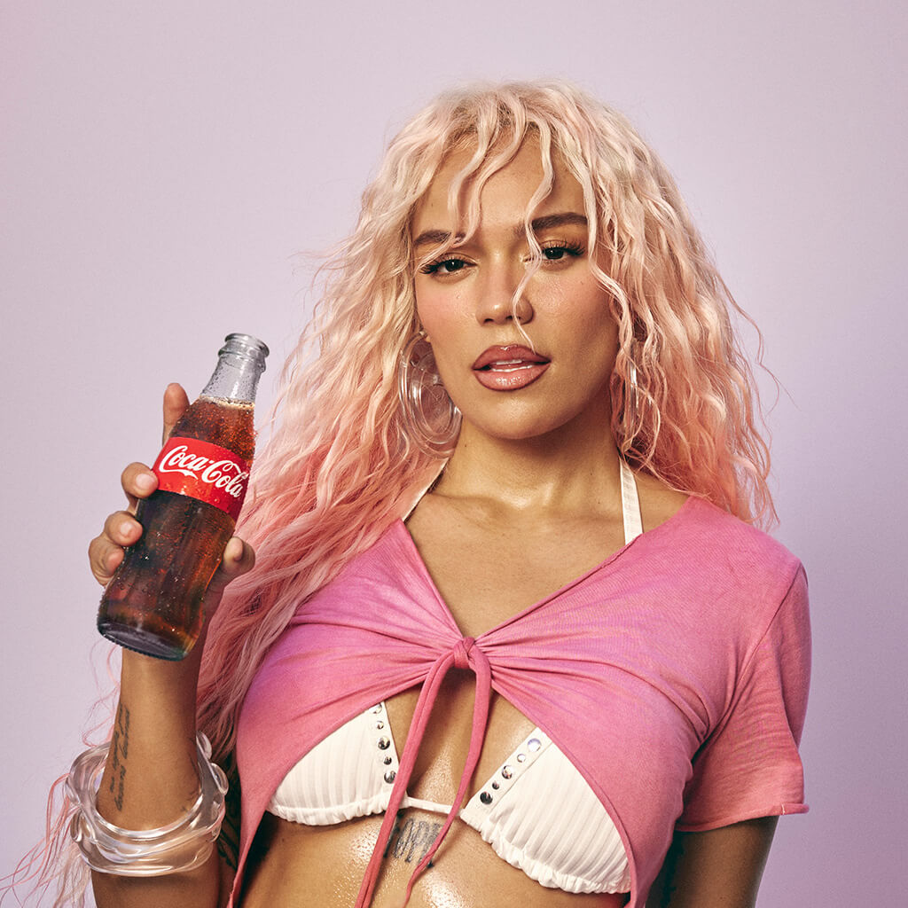 Karol G with a Coca-Cola