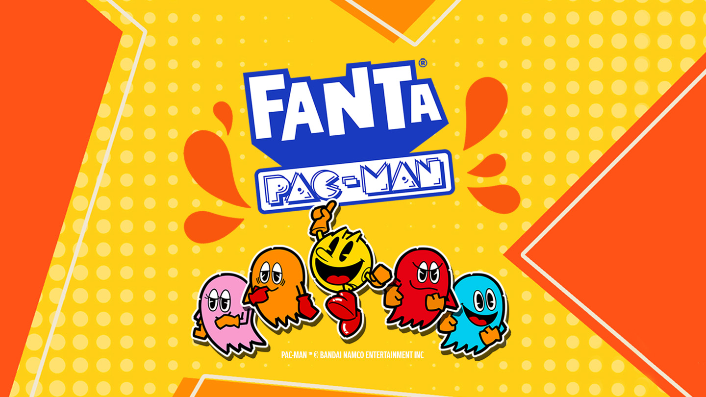  Logo de Tropical con fondo naranja y amarillo y Pac-Man saltando alegremente en el centro, junto con los fantasmas de colores a los lados.
