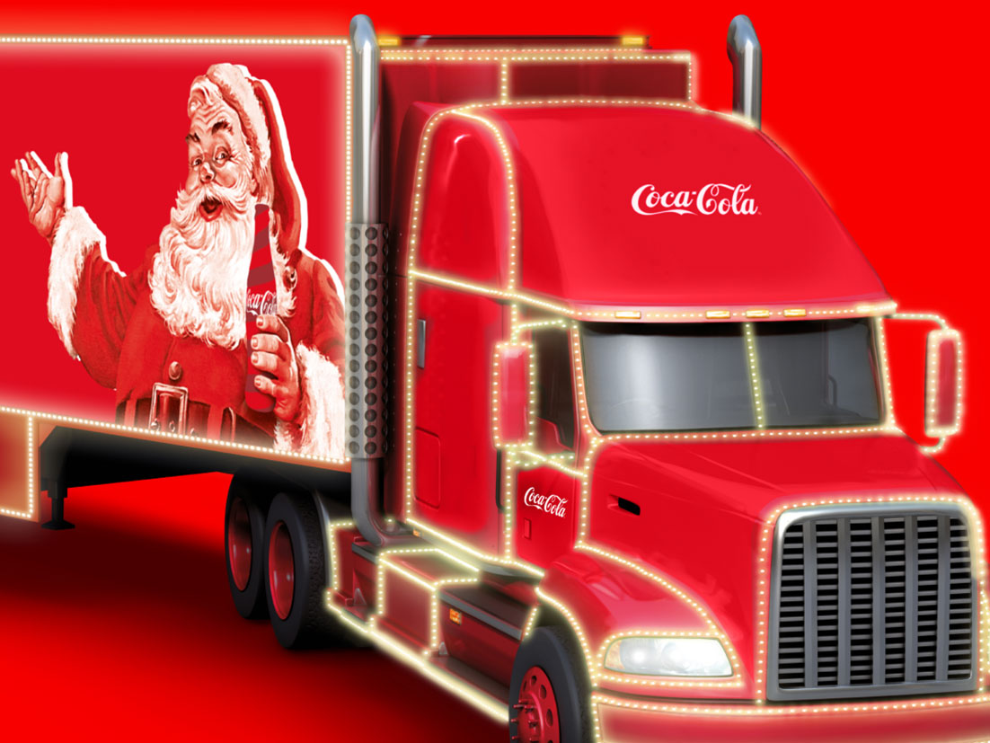 Un camión rojo brillante, una imagen del Viejito Pascuero sosteniendo una Coca-Cola.