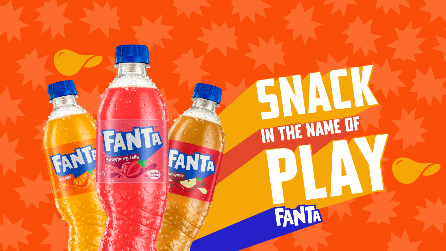 Fanta Orange bottle on a orange background with splashes of Fanta