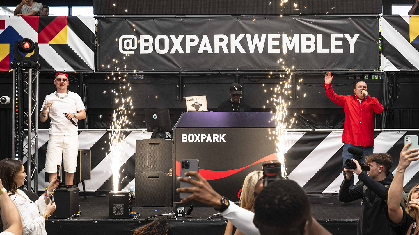 EDITORIAL USE ONLY
Aitch and Shaun Williamson perform Sweet Caroline on the Coca-Cola Zero Sugar stage at BOXPARK in Wembley ahead of England’s UEFA EURO 2024 game against Denmark. Picture date: Thursday June 20, 2024. PA Photo. New research from Coca-Cola Zero Sugar revealed that Sweet Caroline ranked the nation's favourite football anthem, above Three Lions and We Are The Champions. Photo credit should read: John Nguyen/PA Media Assignments