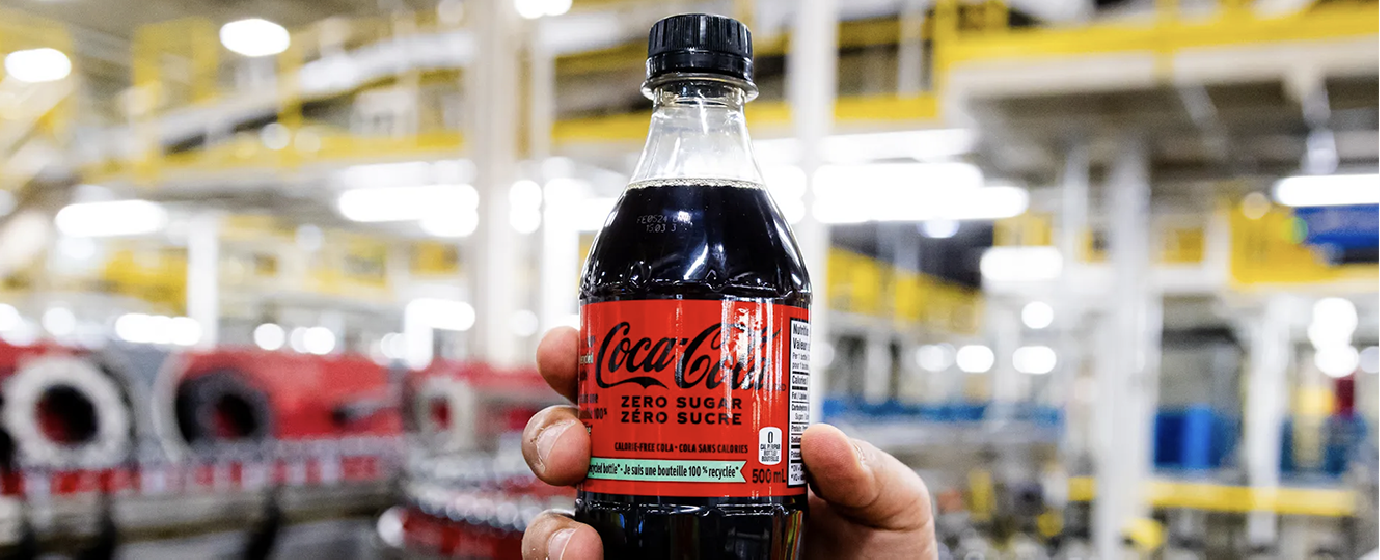 coke-zero in a hand in a bottling plant