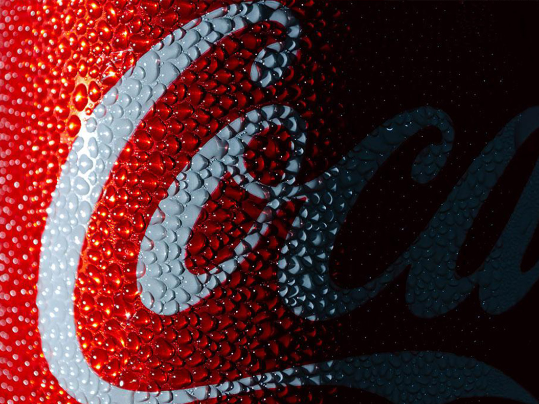 Detail of little bubbles outside a Coca-Cola can on a dark background