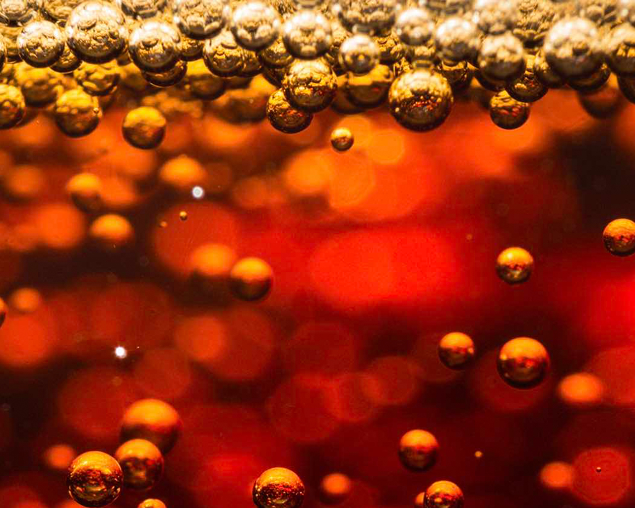 Detail of sparkling bubbles inside a Coca-Cola drink