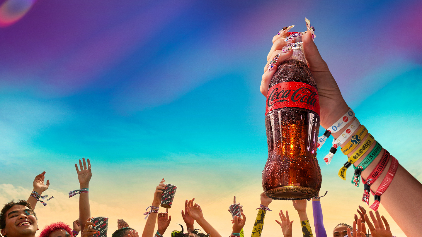 glass bottle of coca-cola at a summer festival