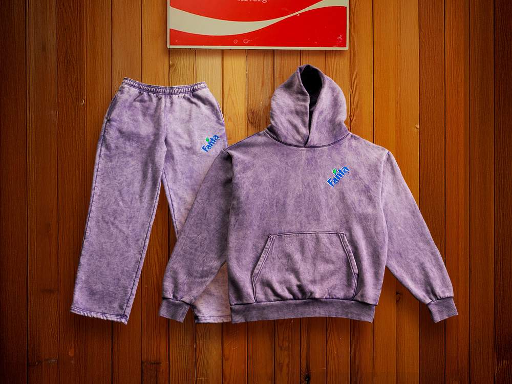 A lavendar sweatsuit with the Fanta logo