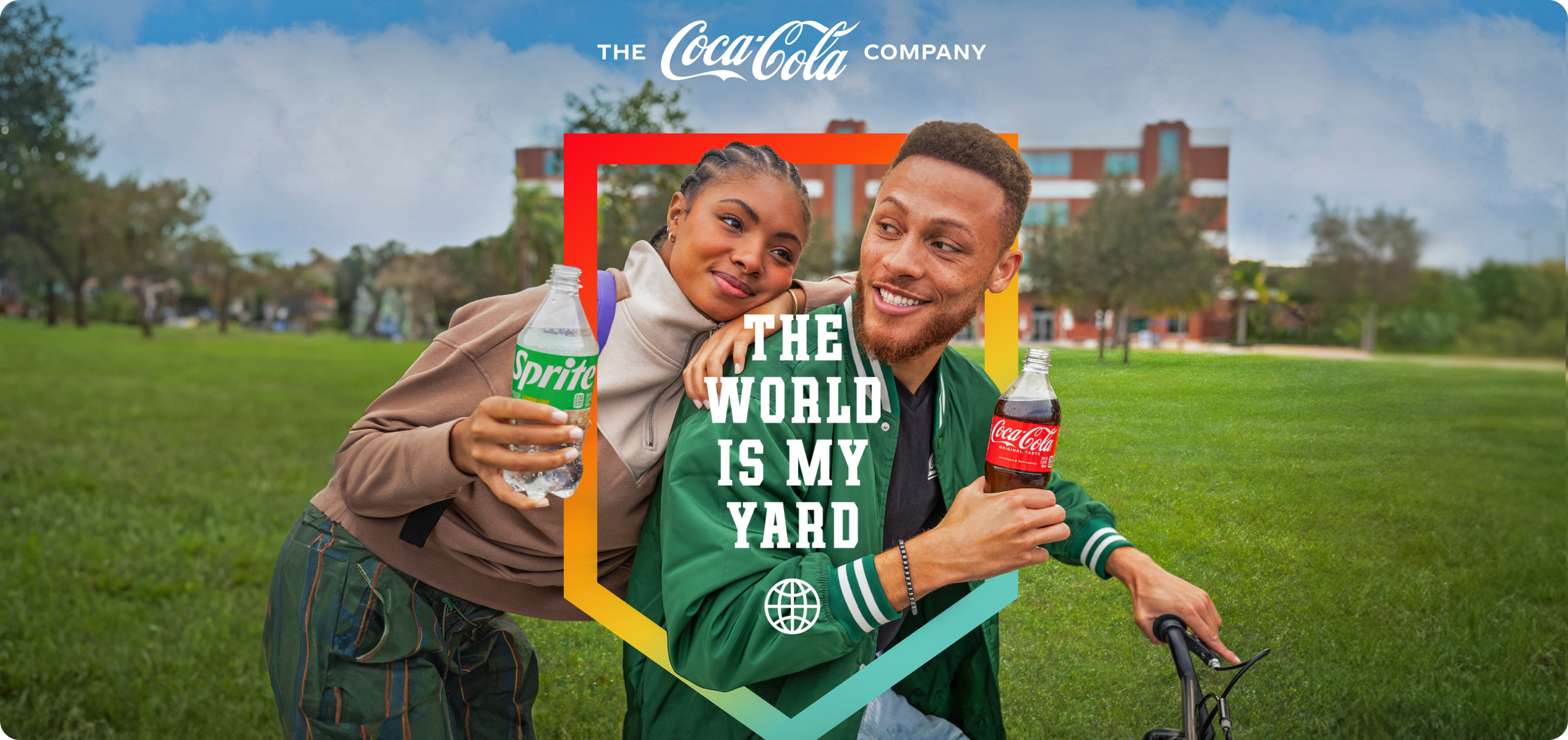 A man on a bike holding a Coca-Cola and a woman leaning against his back holding a Sprite outside on a sunny day