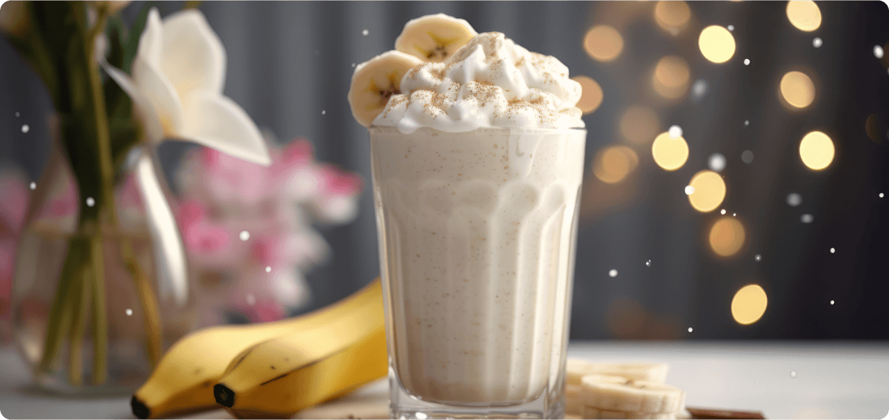 a banana milkshake with whipped cream and banana slices