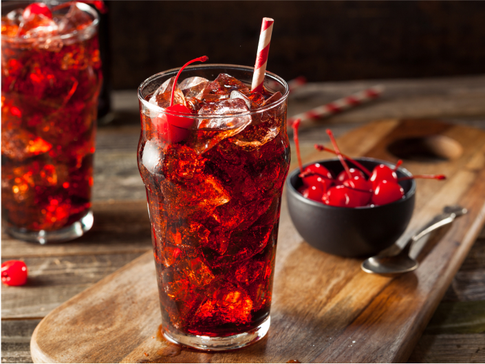 two cola-colored drinks with cherries and straws