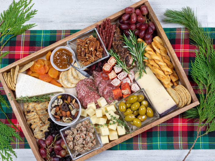 a charcuterie board on a plaid placemat